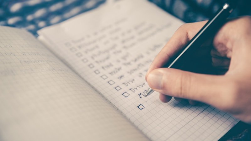 Person working at a desk with a to-do list and calendar for deep work
